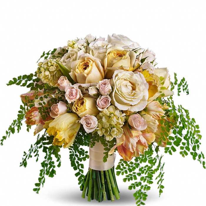 Hand-tied bouquet of ivory and yellow roses with peach parrot tulips and trailing ferns