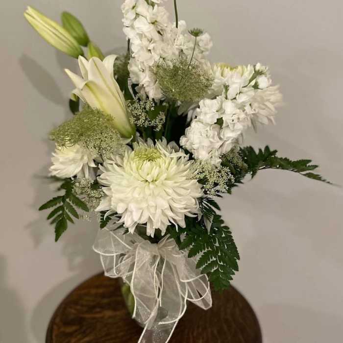 White floral bouquet with lilies, chrysanthemums, and a sheer ribbon