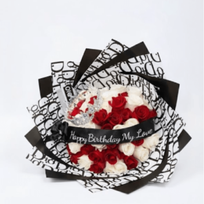 Red and white rose bouquet wrapped in black-and-white paper