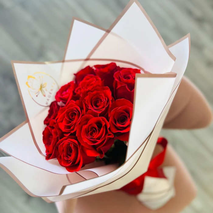 Bouquet of red roses wrapped in white paper
