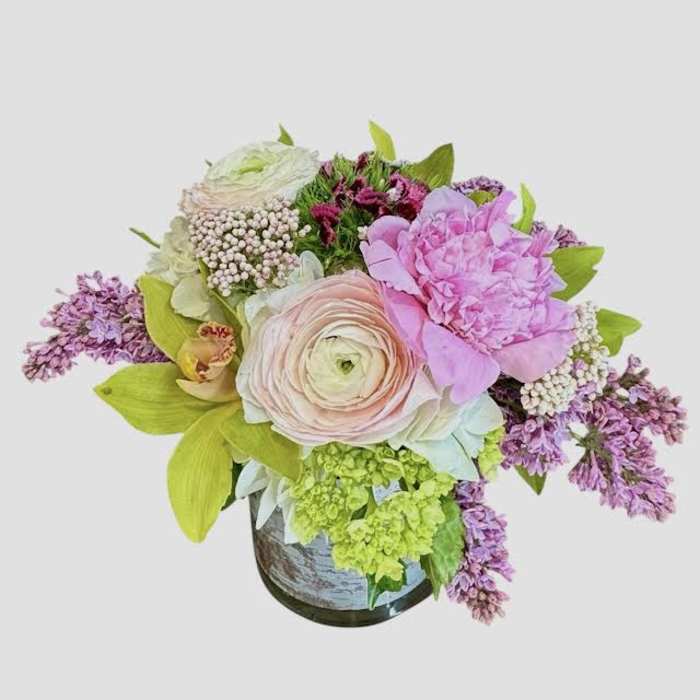 Pastel floral arrangement in a vase with pink and lavender blooms