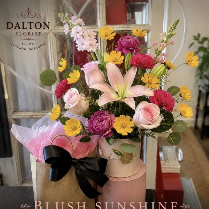 Mixed bouquet with pink roses, lilies, and yellow daisies in a gift box