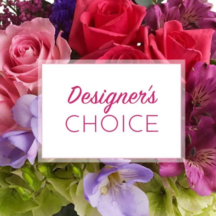 Mixed bouquet of pink and purple flowers with a designer's choice card