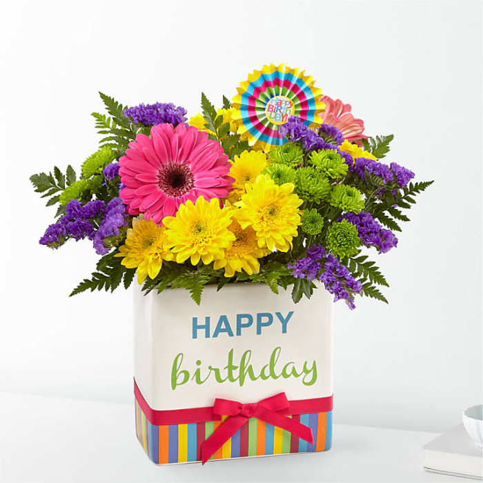 Birthday flower arrangement in a decorated box with a ribbon
