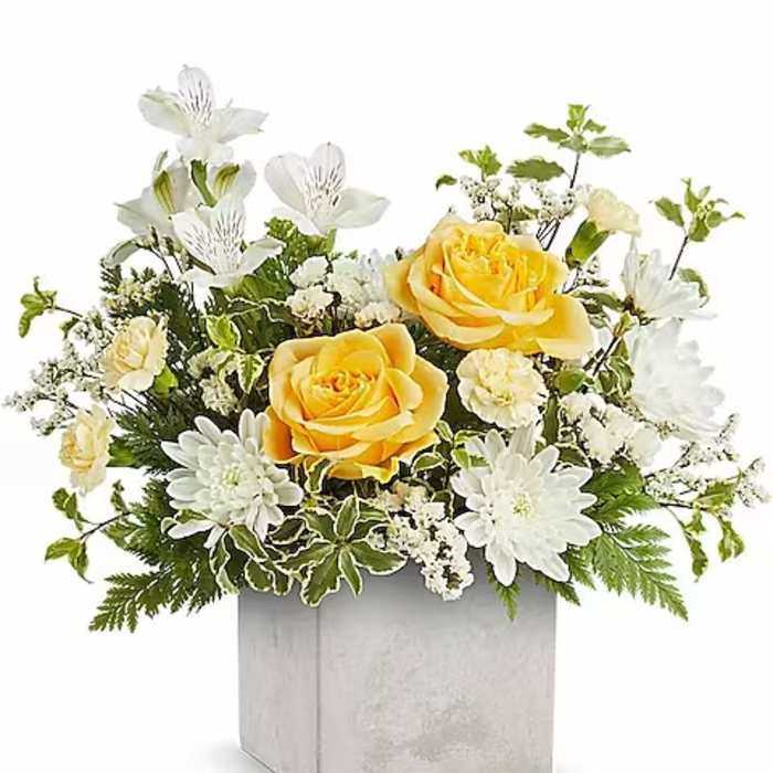 Yellow roses and white flowers in a silver square vase