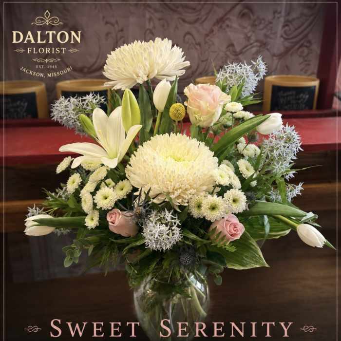 Cream and pink floral arrangement in a clear glass vase