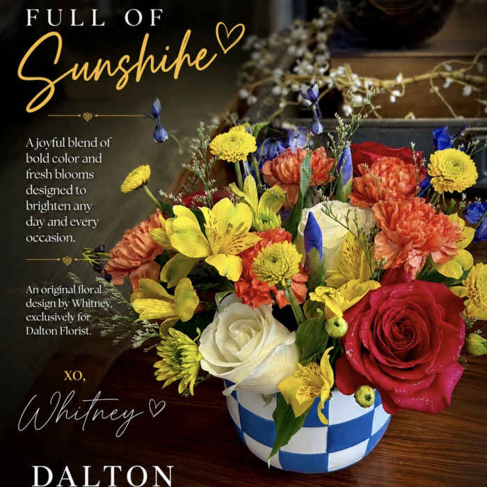 Colorful mixed flower arrangement in a blue-and-white checkered vase
