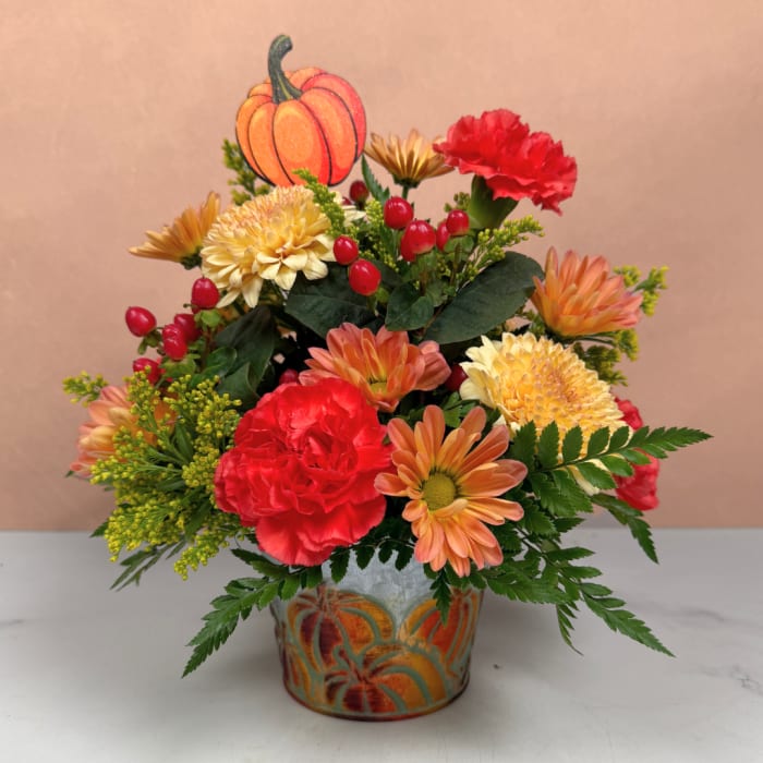 Fall bouquet in a painted metal pot with a pumpkin pick