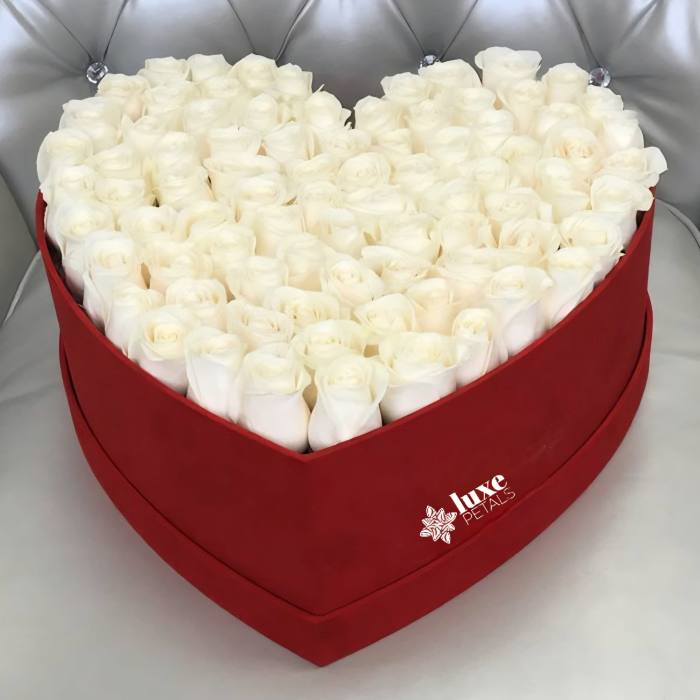 Heart-shaped box filled with white roses