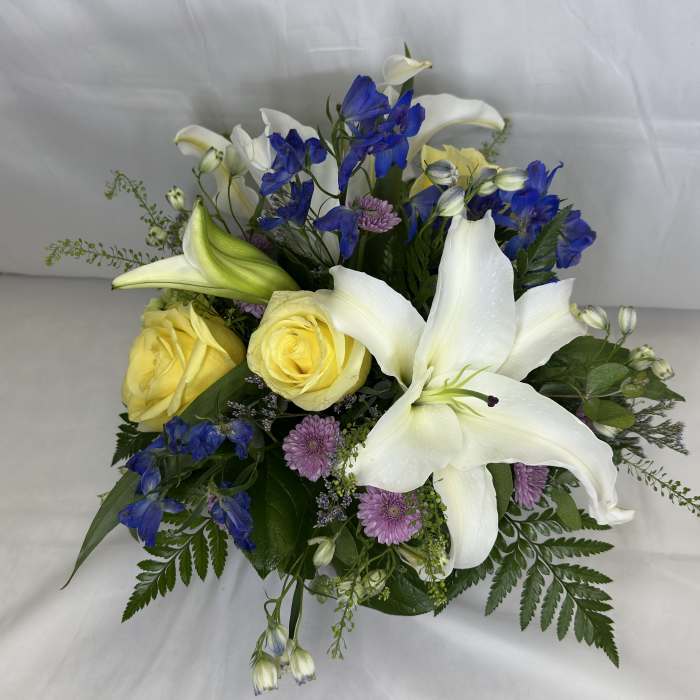Bouquet with white lilies, yellow roses, and blue flowers