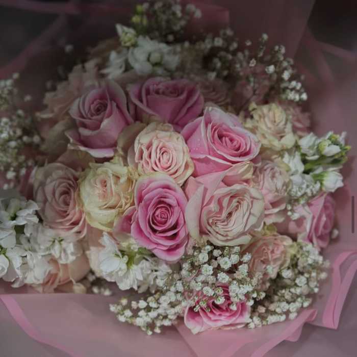 Pink and cream rose bouquet wrapped in pink paper