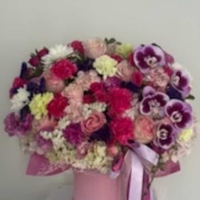Pink and purple mixed bouquet in a pink hat box with ribbon