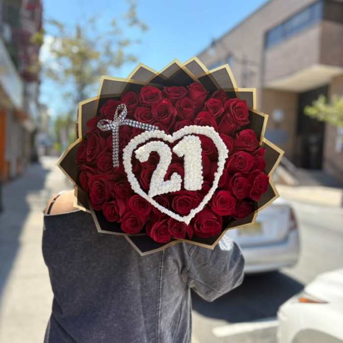 Bouquet of red roses with a white heart and "21" decoration