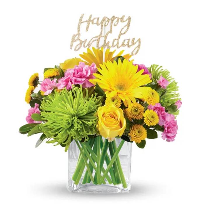 Bright mixed bouquet in a clear vase with a Happy Birthday topper