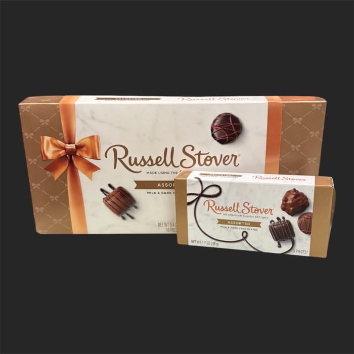 Two boxes of assorted chocolates on a dark background