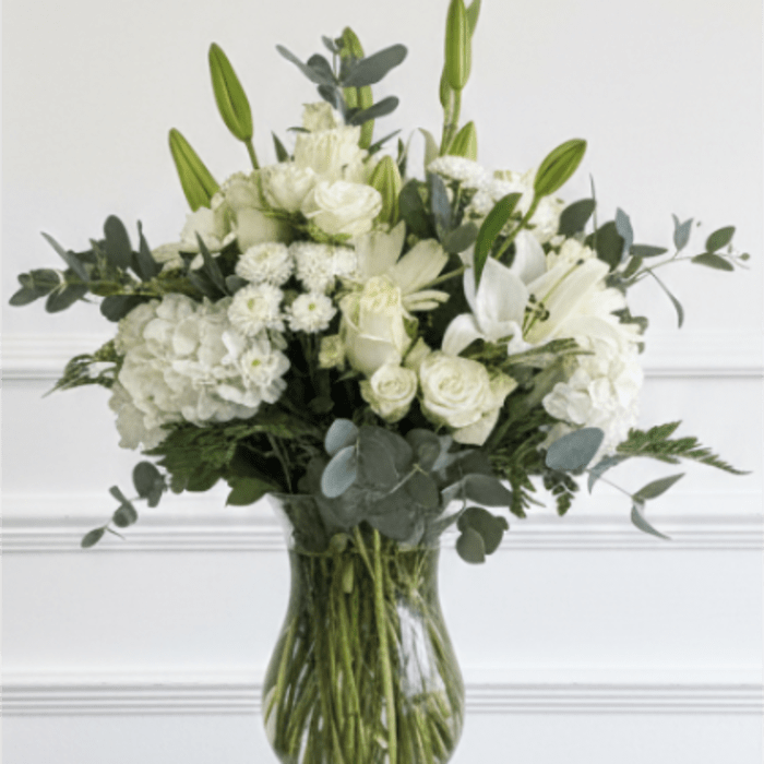 White floral arrangement in a clear glass vase