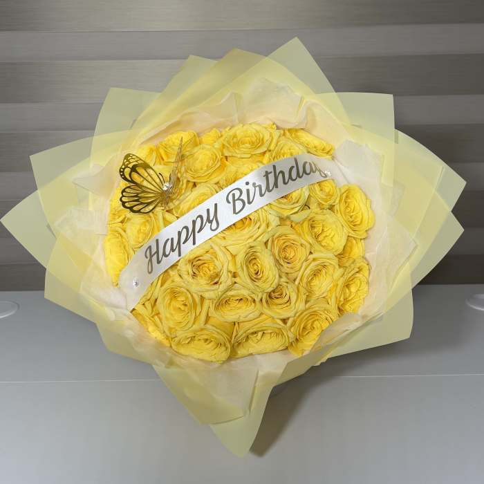 Yellow rose bouquet with a Happy Birthday ribbon and butterfly decoration