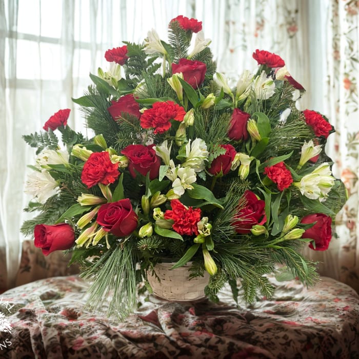 Red roses and white lilies in a basket arrangement