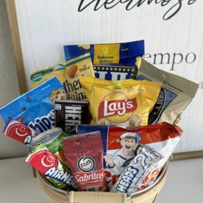 Basket filled with assorted snack bags and candy packages