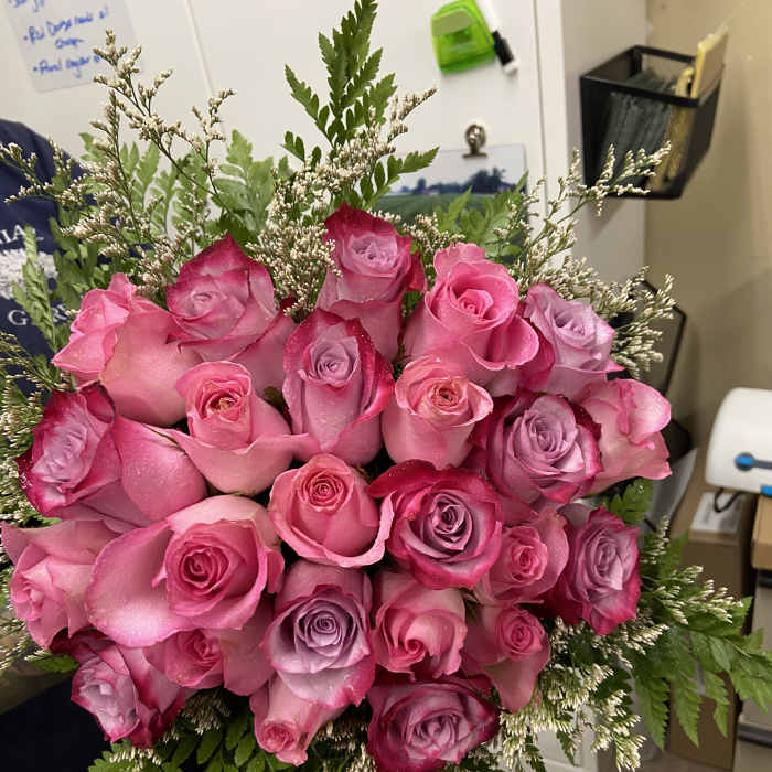 Bouquet of pink and lavender roses with fern filler