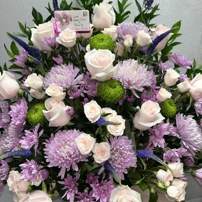 Large bouquet of pale pink roses, lavender chrysanthemums, and green button mums