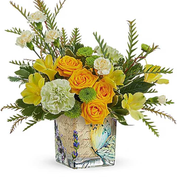 Yellow roses and carnations in a butterfly-printed glass vase