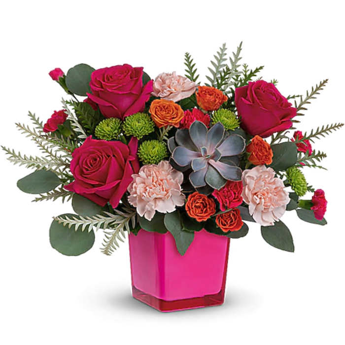 Pink roses and carnations in a bright pink vase with a succulent accent