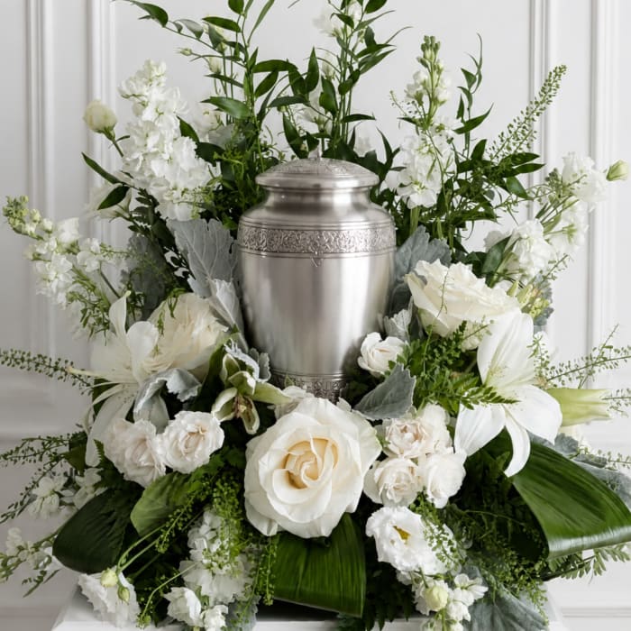 White floral funeral urn arrangement with roses and lilies