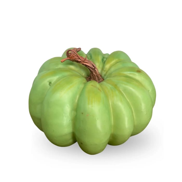 Green decorative pumpkin on a white background