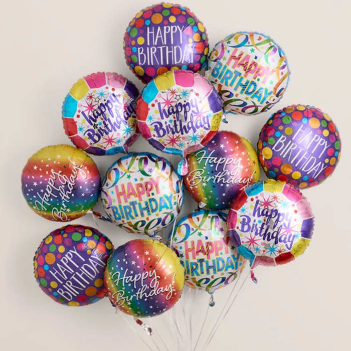 Cluster of colorful "Happy Birthday" balloons against a plain background