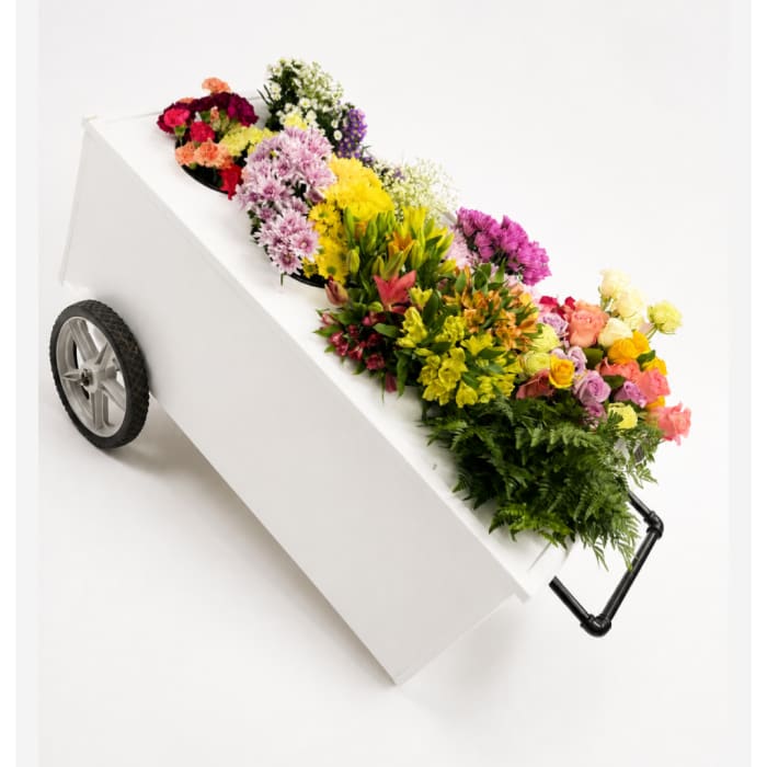 Colorful flowers arranged on a white coffin