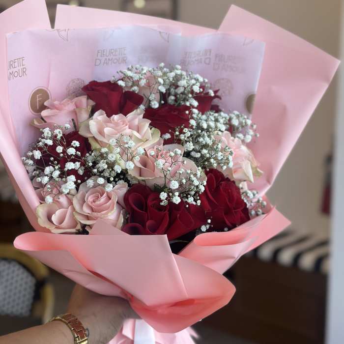 Pink and red rose bouquet wrapped in pastel pink paper