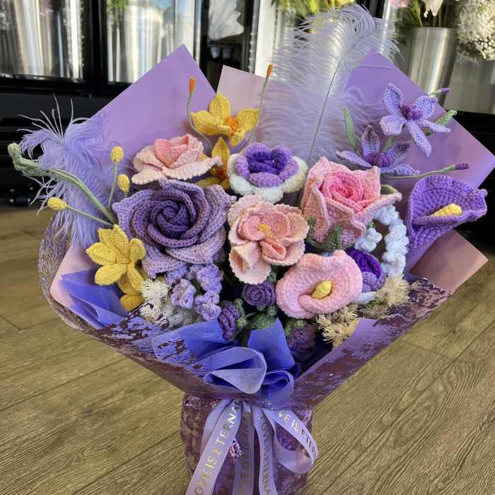 Bouquet of crocheted purple, pink, and yellow flowers wrapped in lavender paper