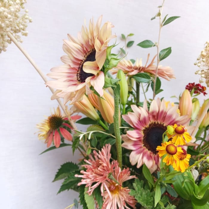 Mixed bouquet with sunflowers, lilies, and yellow daisy-like blooms