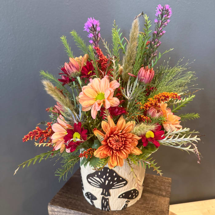 Mixed autumn bouquet in a white mushroom-shaped vase