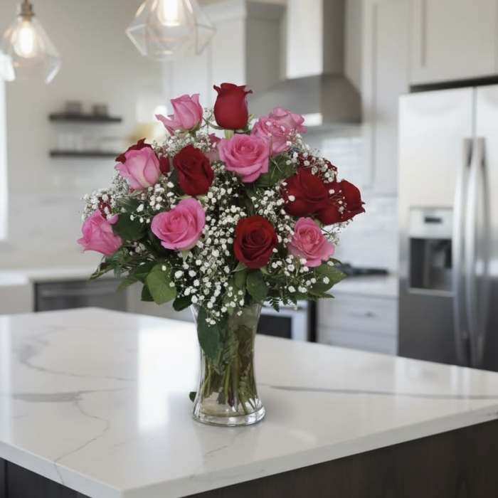 Bouquet of pink and red roses in a clear glass vase