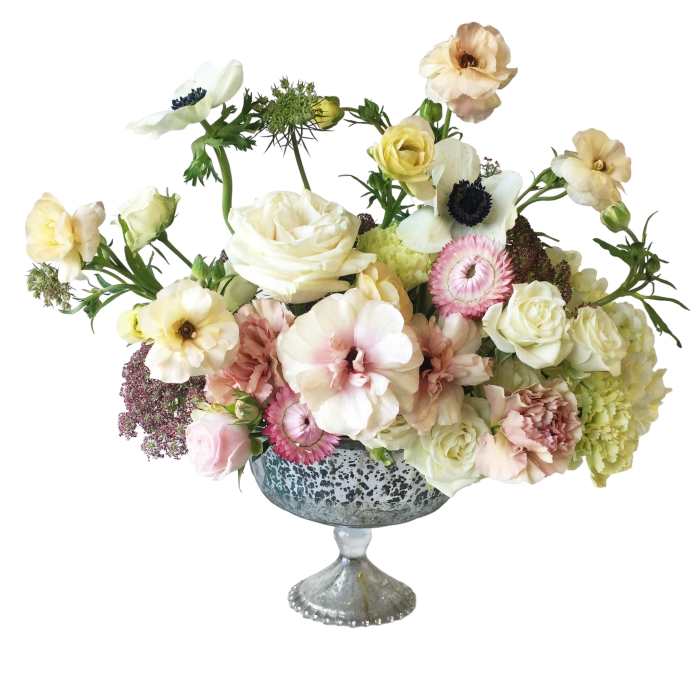 Mixed pastel flower arrangement in a silver pedestal vase