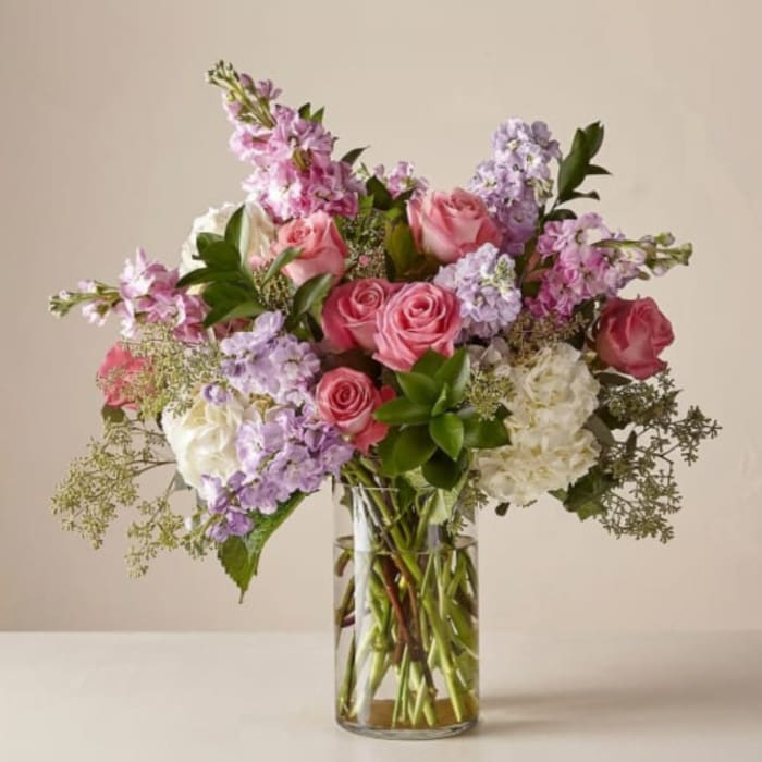 Pink and lavender mixed bouquet in a clear glass vase