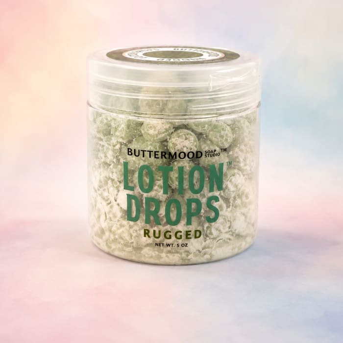 Jar of lotion drops with a pastel background