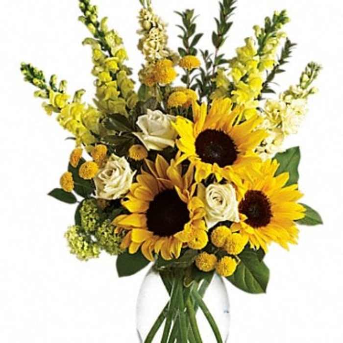 Sunflowers and white roses in a clear glass vase