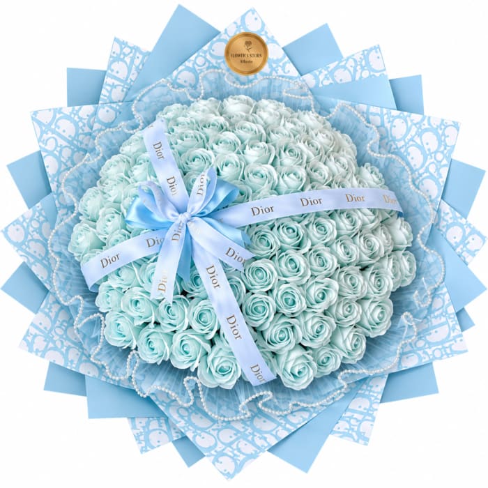 Bouquet of pale blue roses wrapped in patterned blue paper with a ribbon