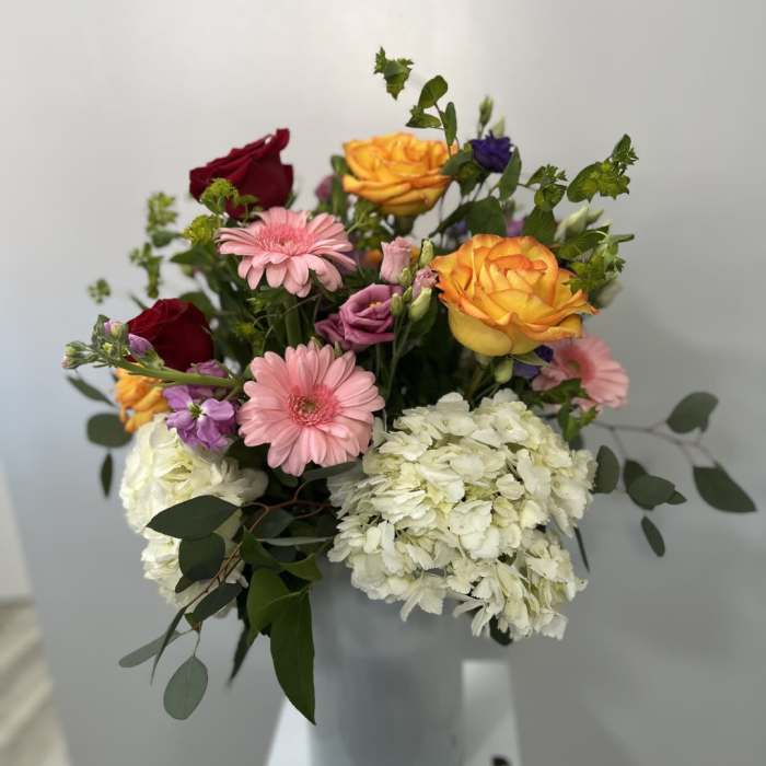 Mixed bouquet with roses, gerbera daisies, and white hydrangeas in a vase