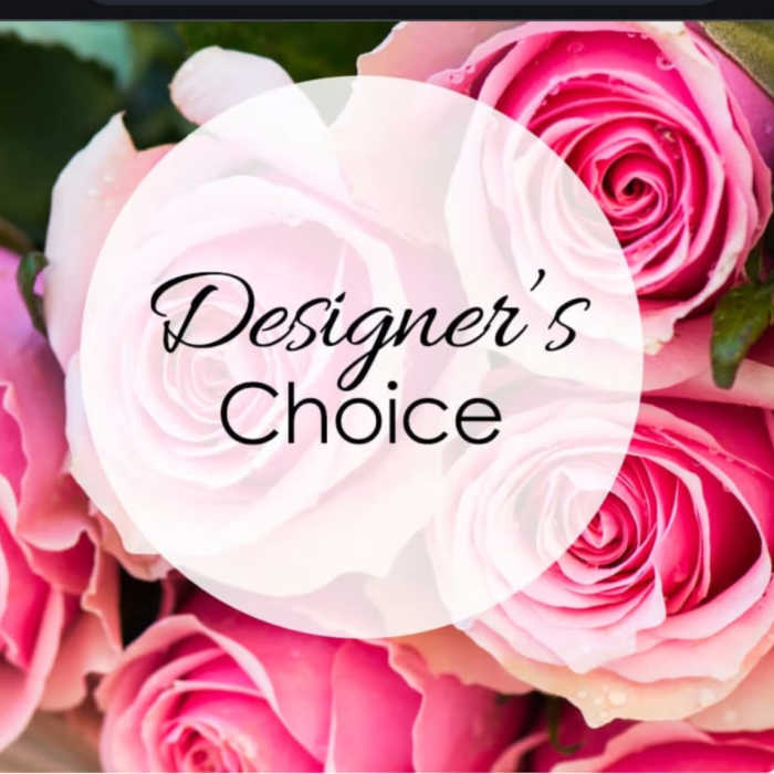 Pink roses with a "Designer’s Choice" label over the center