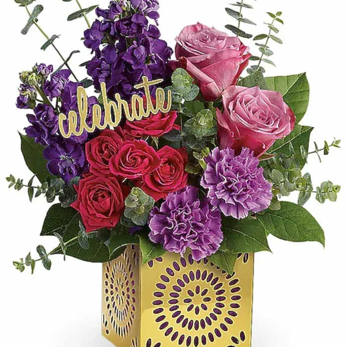 Bouquet of pink and purple flowers in a yellow decorative box