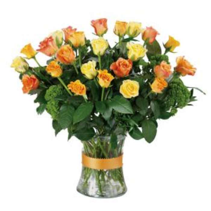Bouquet of yellow and orange roses in a clear glass vase