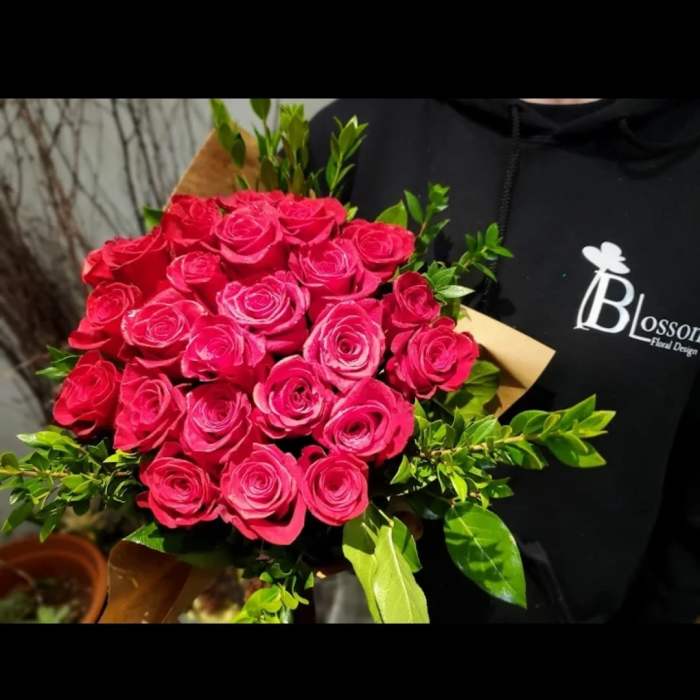 Bouquet of bright pink roses with green foliage