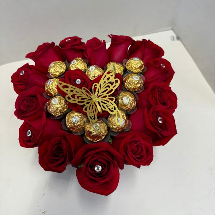 Heart-shaped bouquet of red roses with gold-wrapped chocolates and a butterfly topper