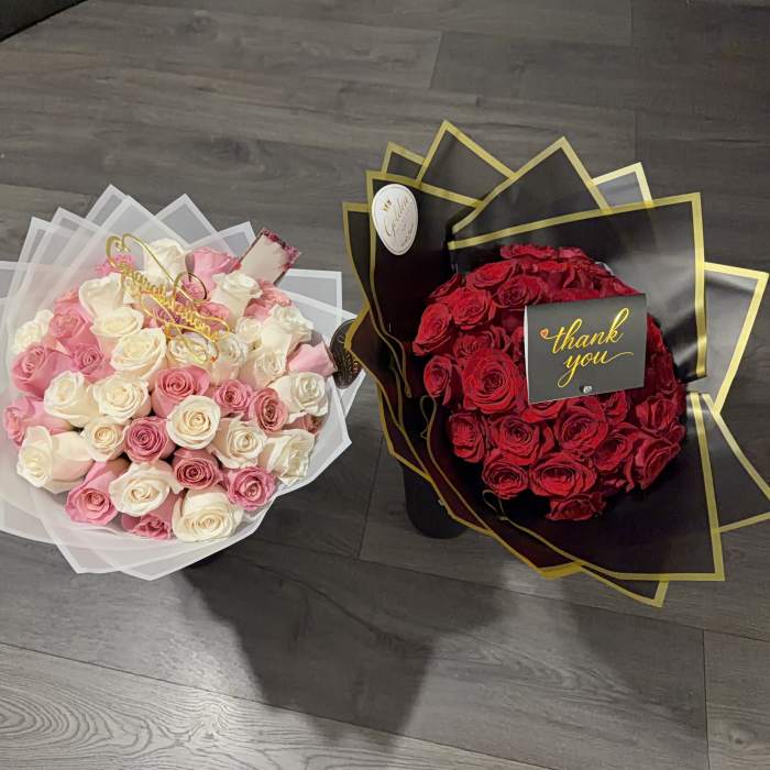 Two rose bouquets, one pink and white and one red, wrapped in decorative paper
