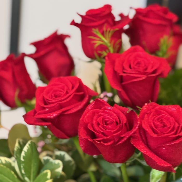 Close-up bouquet of red roses with green foliage