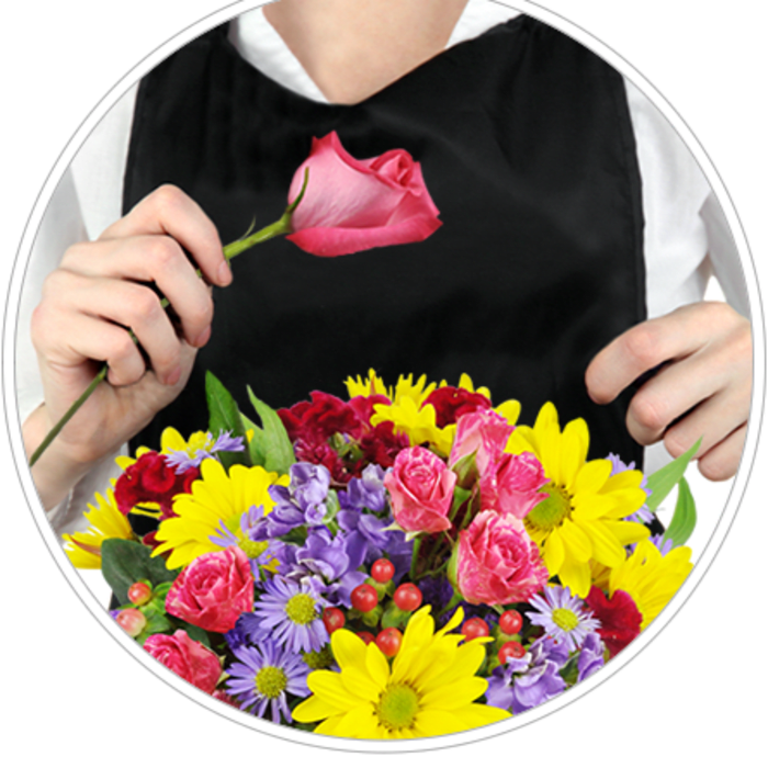 Person holding a pink rose above a colorful mixed bouquet